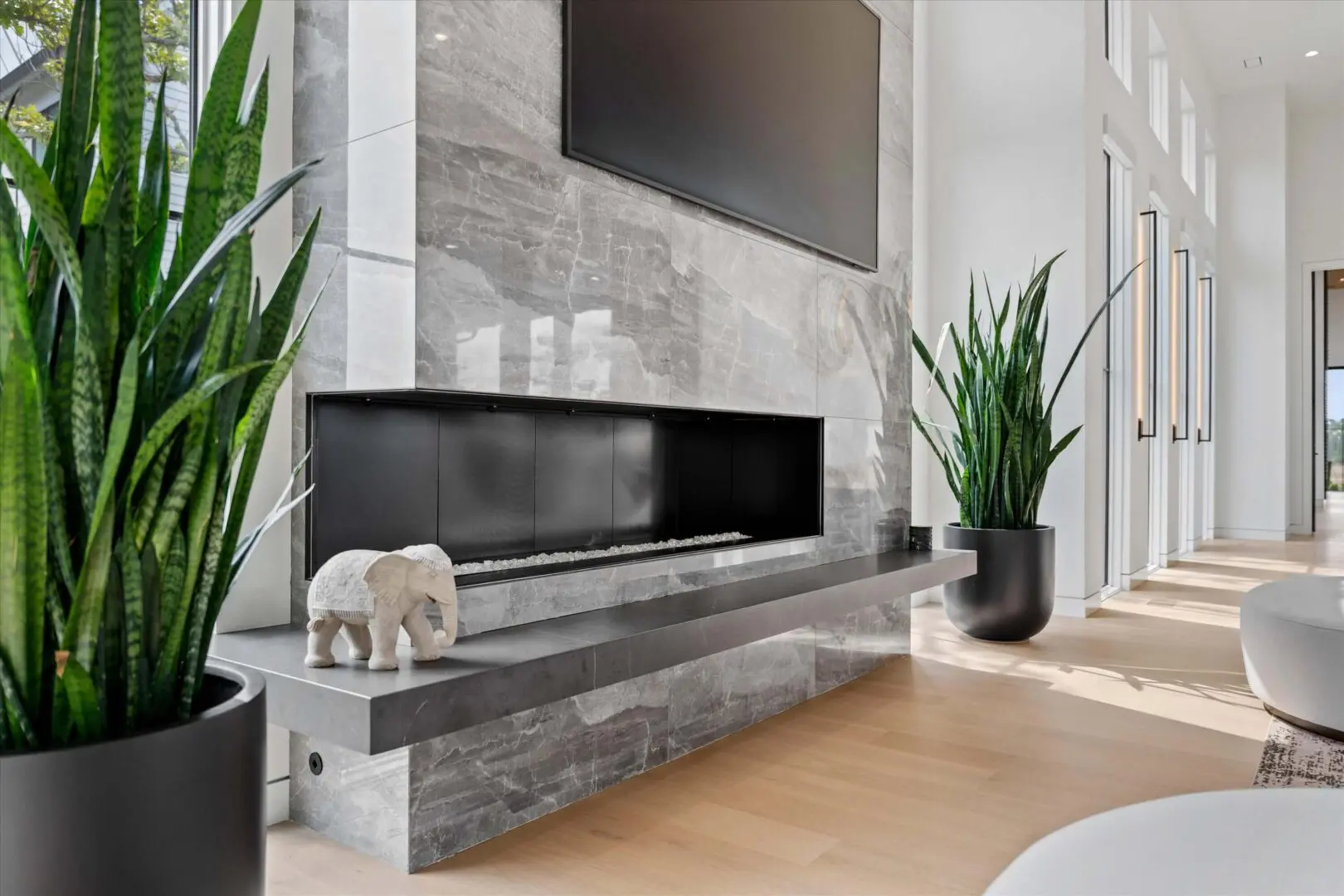 Modern living room with a sleek fireplace and minimalist decor.